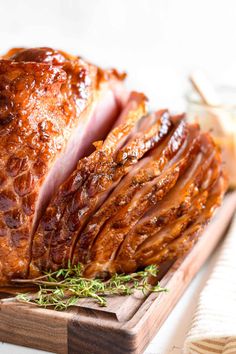 a ham is sitting on a cutting board