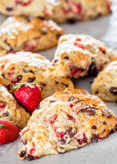 some scones with strawberries and chocolate chips on them