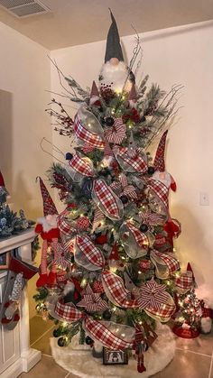 a christmas tree decorated with red, white and blue ribbons