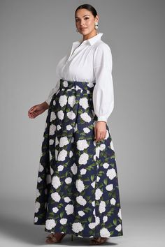 Florence is classic versatility at it's finest. Her top features a pearled button down silhouette in Indian cotton while the bottom is a navy, subtly pleated ball skirt with ivory printed peonies. The two are met in the middle with a printed belt for a flattering, waist-cinching look.Details:Model is 5'10" wearing size 2Full-Length, 60" from top of shoulder to bottom hemFront Button Closure Indian Cotton - Printed Poly Faille 100% PolyesterImportedStyle #S242G18-416 Elegant Voluminous Skirt For Garden Party, Elegant Full Skirt For Garden Party, Elegant Floral Print Skirt For Daywear, Elegant Floral Print Voluminous Skirt, Elegant Voluminous Floral Print Skirt, Elegant Dresses With Lined Skirt For Garden Party, Elegant Floral Print Skirt For Formal Occasions, Elegant Formal Skirt With Floral Print, Elegant Formal Floral Print Skirt