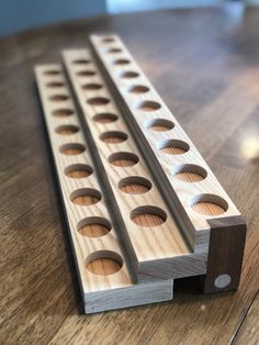 a close up of a wooden object on a wood floor with holes in the middle