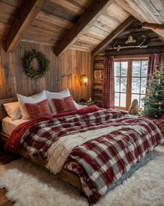 a bed in a room with a plaid comforter on top of it and a christmas wreath hanging from the ceiling