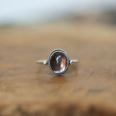 Sometimes you want to gaze down at your ring and see perfect balance and grace. That's what this Dainty Smoky Quartz Delica Ring has to offer. High-grade smoky quartz stone with a simple, sterling silver design. Perfect little ring. Lovely, traditional, dainty ring of 10X12 mm Smoky quartz cabochon set in .925 sterling silver oxidized and burnished bezel and wire. Simple, elegant and perfect. This lovely, translucent, and sparkling warm, taupe grey-colored ring is created using traditional silve Smokey Quartz Ring, Elegant Smoky Quartz Gemstone Rings, Smoky Quartz Gemstone Ring Jewelry, Silversmith Rings, Chloe Ring, Smoky Quartz Gemstone Jewelry, Handmade Brown Smoky Quartz Jewelry, Smoky Quartz Ring, Purple Rings