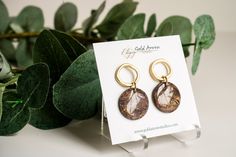 Elevate your style with our Brown Marble Dangle. Handcrafted with beautiful brown and translucent white clay, accented with flecks of gold, this earring will add a touch of sophistication to any outfit. The elegant wavy gold circle post adds a luxurious touch to this exclusive piece. a beautiful mix of my own creation to give you a faux agate look that is light weight and makes the perfect dangle for fall or anytime! micro pave rhinestones on huggie hoop Diamond Dangles have a length of about 2" Earthy Gold Earrings For Gift, Chic Brown Round Jewelry, Earthy Gold Drop Earrings, Gold Earthy Everyday Earrings, Brown Circular Earrings As Gift, Brown Circular Earrings For Gift, Brown Circular Earrings For Gifts, Earthy Gold Everyday Earrings, Earthy Gold Jewelry For Gifts