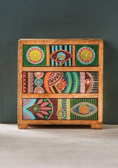 a wooden box with colorful designs painted on it