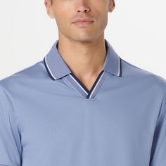 This short-sleeved polo shirt in 100% Pima cotton features rib knit Johnny collar and double contrast tipping detail. Pima cotton is known for its luxurious softness and durability and this shirt is the fusion of one the finest materials with thoughtful detailing. Blue Polo Collar Top With Contrast Trim, Sporty Tops With Contrast Trim And Collared Neckline, Modern Collared Top With Contrast Trim, Modern Cotton Polo Shirt With Contrast Collar, Fitted Golf Tops With Striped Collar, Modern Short Sleeve Top With Striped Collar, Sporty Polo Shirt With Contrast Collar And Short Sleeves, Modern Polo Shirt With Striped Collar, Modern Polo Top With Striped Collar