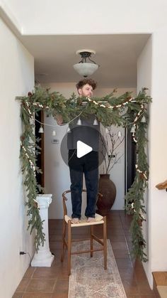 Christmas Garland Over Curtains, Christmas Garland Hanging Lights, Around The Door Christmas Decor, Tall Ceiling Christmas Decor, Hanging Branch Christmas Decorations, Hallway Holiday Decorating, Sticking Hanging Ideas No Fireplace, Door Way Christmas Garland, Hallway Xmas Decorations