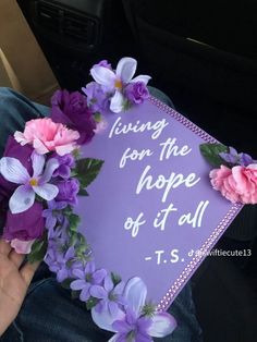 a purple graduation cap decorated with flowers and the words living for the hope of it all