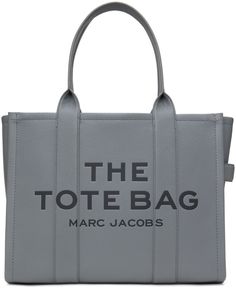 Grained leather tote in gray. · Twin rolled shoulder straps · Logo embossed at face · Leather loop at side · Logo patch at back face · Zip closure · Zip pocket at interior · Patch pockets · Twill and buffed leather lining · H13 x W16 x D7 Supplier color: Wolf grey Marc Jacobs The Tote Bag, Largest Wolf, Grey Bag, The Tote Bag, Tote Bag Leather, Branded Bags, Large Tote, Grey Leather, Winter Style