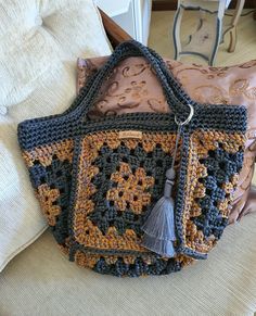 a crocheted purse sitting on top of a couch