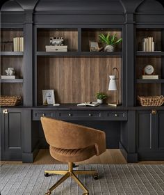 a home office with built - in bookcases, desk and chair is shown