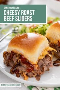 a plate with two sandwiches on it and the words cheesy roast beef sliders