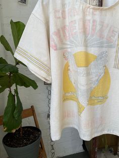 Handmade, one of a kind t shirt made using a vintage feedsack and apron from the 1940s. Very lightweight and breezy cotton. Pocket tee and striped sleeve detail. Please note there are areas of light staining, discoloration, and small distressed areas. Can fit a size small or medium best, or can be worn oversized. Has a boxy, slightly cropped fit. Gender neutral. All sales are final, so please refer to measurements and look carefully through the photos. Please feel free to reach out with any ques Western Farmhouse, Feed Sacks, Striped Sleeve, Pocket Tee, Sleeve Detail, Quilt Blanket