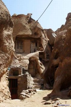 an old house built into the side of a rock cliff in wadia, jordan