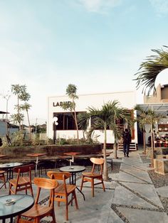 an outdoor restaurant with tables and chairs