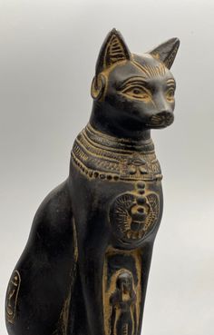 an egyptian cat statue sitting on top of a table