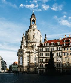 an old building with a clock tower in the middle of it's center square