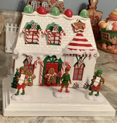 a white gingerbread house with christmas decorations