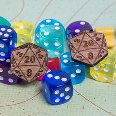 colorful dices with numbers on them sitting on a table next to other dices