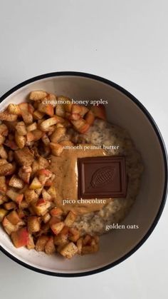 a bowl filled with oatmeal, apples and chocolate