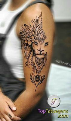 a woman's arm with a lion tattoo on it, and flowers in the middle