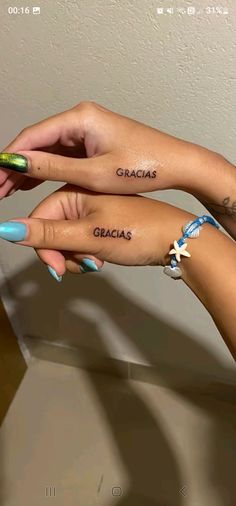 two people with matching tattoos on their hands