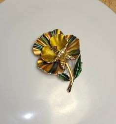 "This vintage orchid yellow and green enamel painted pin brooch is a beautiful addition to anyone's jewelry collection. The colorful design is intricate and the pin is made from high quality materials. It would make a great gift for someone special. Measures: 2.5\"x2\" Every order comes in a beautiful gift bag." Green Flower-shaped Enamel Brooch Pin, Green Flower Shaped Enamel Pin Brooch, Green Flower Enamel Pin Brooch, Collectible Gold Flower Enamel Pin, Yellow Enamel Brooches For Gifts, Orchid Yellow, Retro Hats, Enamel Paint, Yellow And Green