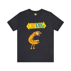 Step back into '90s nostalgia with our CatDog Retro Cartoon Short Sleeve T-Shirt. This Nickelodeon classic comes to life on a comfortable and stylish tee that's perfect for fans of all ages. Show your love for CatDog with this unique design that's bound to spark conversations and fond memories. Whether you watched it as a kid or discovered it later, this shirt is a must-have for fans of this iconic duo. Don't miss out on the chance to wear your favorite '90s cartoon wherever you go. Funny Character Print Streetwear T-shirt, Funny Character Print T-shirt For Streetwear, Funny Unisex Cartoon Print T-shirt, 90s Crew Neck T-shirt With Character Print, 90s Character Print Crew Neck T-shirt, 90s Nick, Vibrant Illustration, Iconic Duo, Retro Cartoon