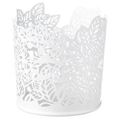 a white paper cup with cut out leaves on the top and bottom, sitting in front of a white background