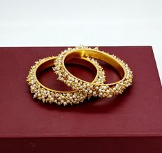 ❖ ❖ ❖ Features:- ❖ An Indian styled pearl bangles. ❖ Made from fine Quality Brass with Gold Platting. ❖ Ready to be given as a gift. ❖ Easy and Convenient way to Wear. ❖ It looks prettier than the images. Direct Images on hand is also attached. Size of Bangle & Other Details:- ❖ Size:- 2.8 diameter 2.5 Inches approx ❖ Quantity:- One Pair ❖ Material:- Gold Plated Brass Price Is For 1 Pair Bangle Set This pear bracelet is glamorously impressive, yet subtle, the design is clean and extremely ac Elegant Festive Bangle With Round Beads, Elegant Beaded Bangle For Festive Occasions, Gold Bohemian Pearl Bracelet For Wedding, Festive Pearl Bracelet For Gift, Festive Pearl Bracelet Perfect For Gifts, Sangeet Outfit, Pearl Bangle, Wedding Bridesmaid Jewelry, Bangles Indian