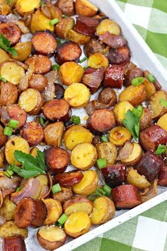 roasted potatoes with parsley and herbs in a white dish on a green checkered tablecloth