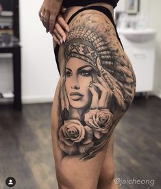 a woman with tattoos on her thigh and leg is holding roses in front of her face