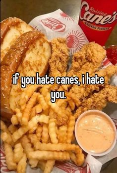 a basket filled with fried chicken and french fries next to a cup of ketchup