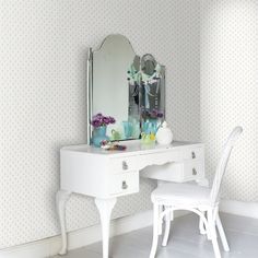 a white desk with a chair and mirror