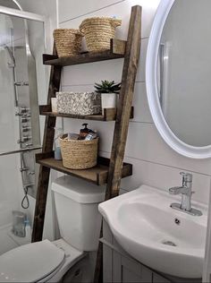 a bathroom with a wooden ladder leaning over the toilet and sink, next to a mirror