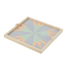 a wooden tray with an orange and green design on the bottom, in front of a white background