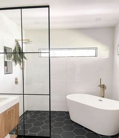 a white bath tub sitting next to a walk in shower