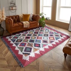 a living room with a couch, chair and rug