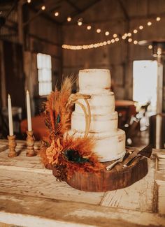 a wedding cake sitting on top of a wooden table