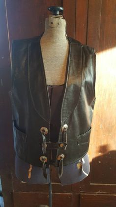 Awesome leather vest. Size 42 chest. Two snap closures. See where leather and liner are separating at arm pit seam in photo. Fitted Leather Biker Vest, Luxury Leather Biker Vest, Black Leather Vest Vintage, Leather Sleeveless Vest For Motorcycling, Vintage Leather Vest, Fabric Napkin, Mens Vests, Leather Vest, Biker Style