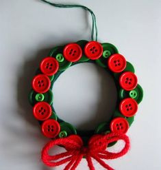 a red and green wreath with buttons on it