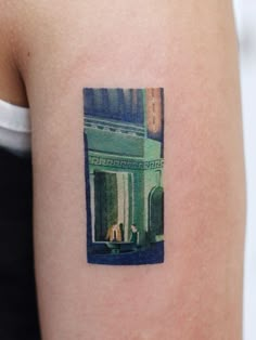 a woman's arm with a small photo on the left side of her arm