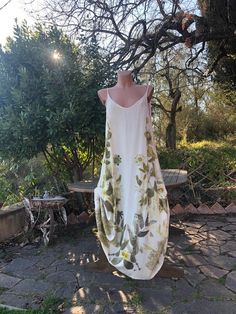 a white dress hanging on a tree branch