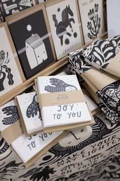 several greeting cards are stacked on top of each other, with the words joy to you printed in black and white