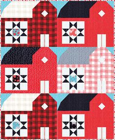 a quilt with red and white houses on it