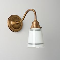 a white and gold light fixture on a wall