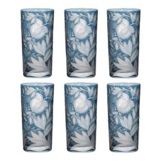 four blue glass tumblers with white flowers on the outside and one in the middle