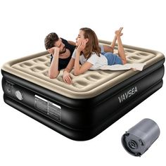 an inflatable mattress with two people laying on it next to a blow up heater