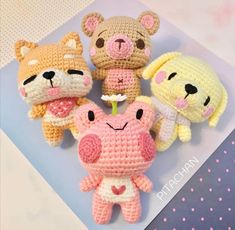 four crocheted stuffed animals sitting next to each other