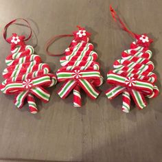 two christmas tree ornaments on a table